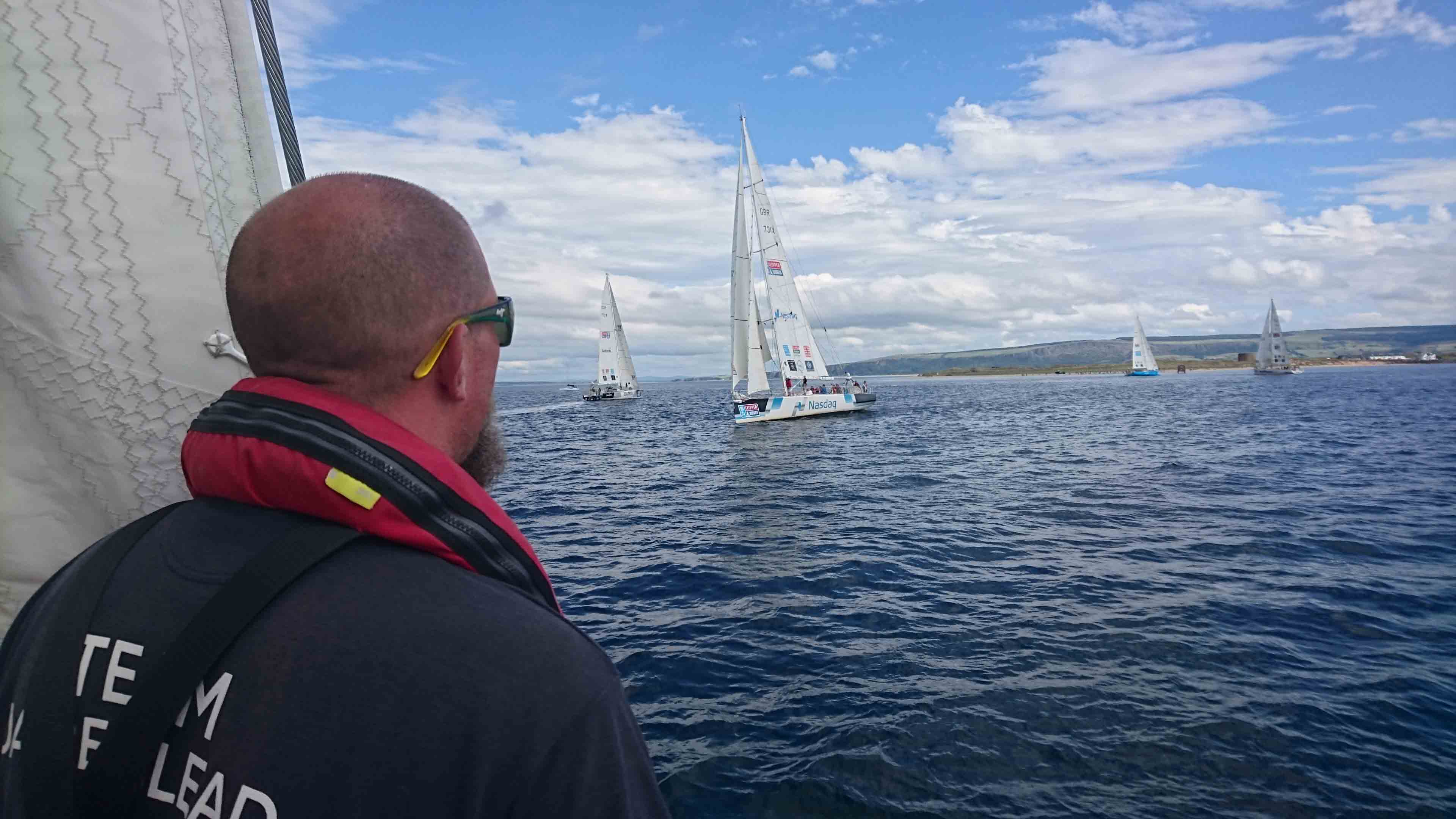 Dsre to Lead Crew Member looks out at competing yachts 