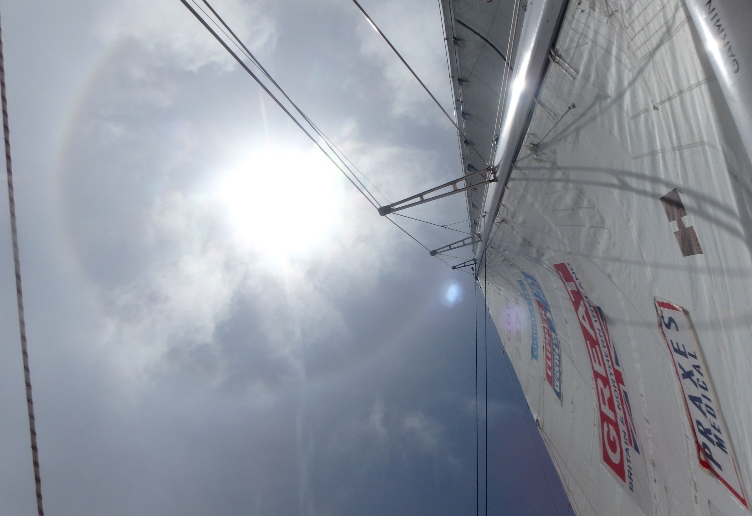 The sun shown shining strongly, looking upwards from GREAT Britain's mainsail