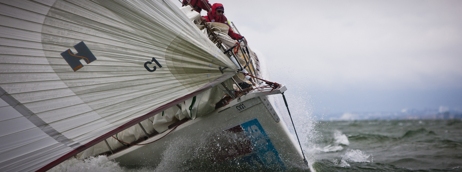 The bow of a Clipper yacht pictured racing