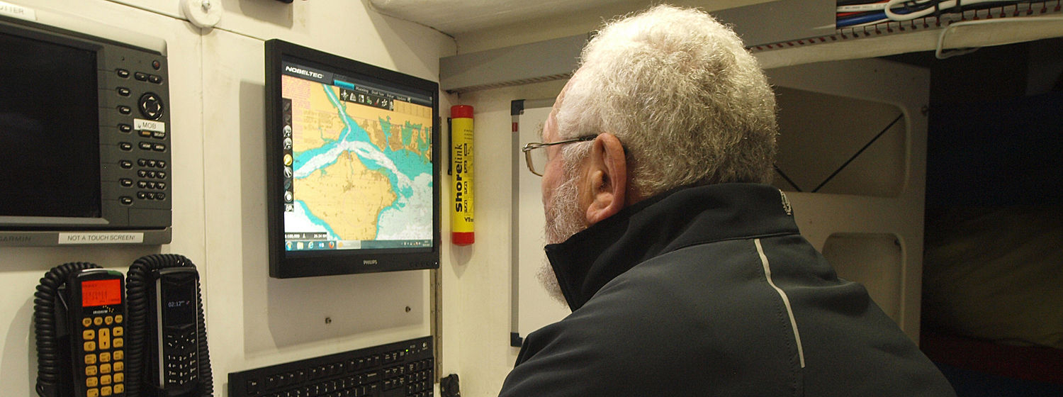 Sir Robin pictured looking at the Nobeltec navigation screen onboard a Clipper 70 yacht