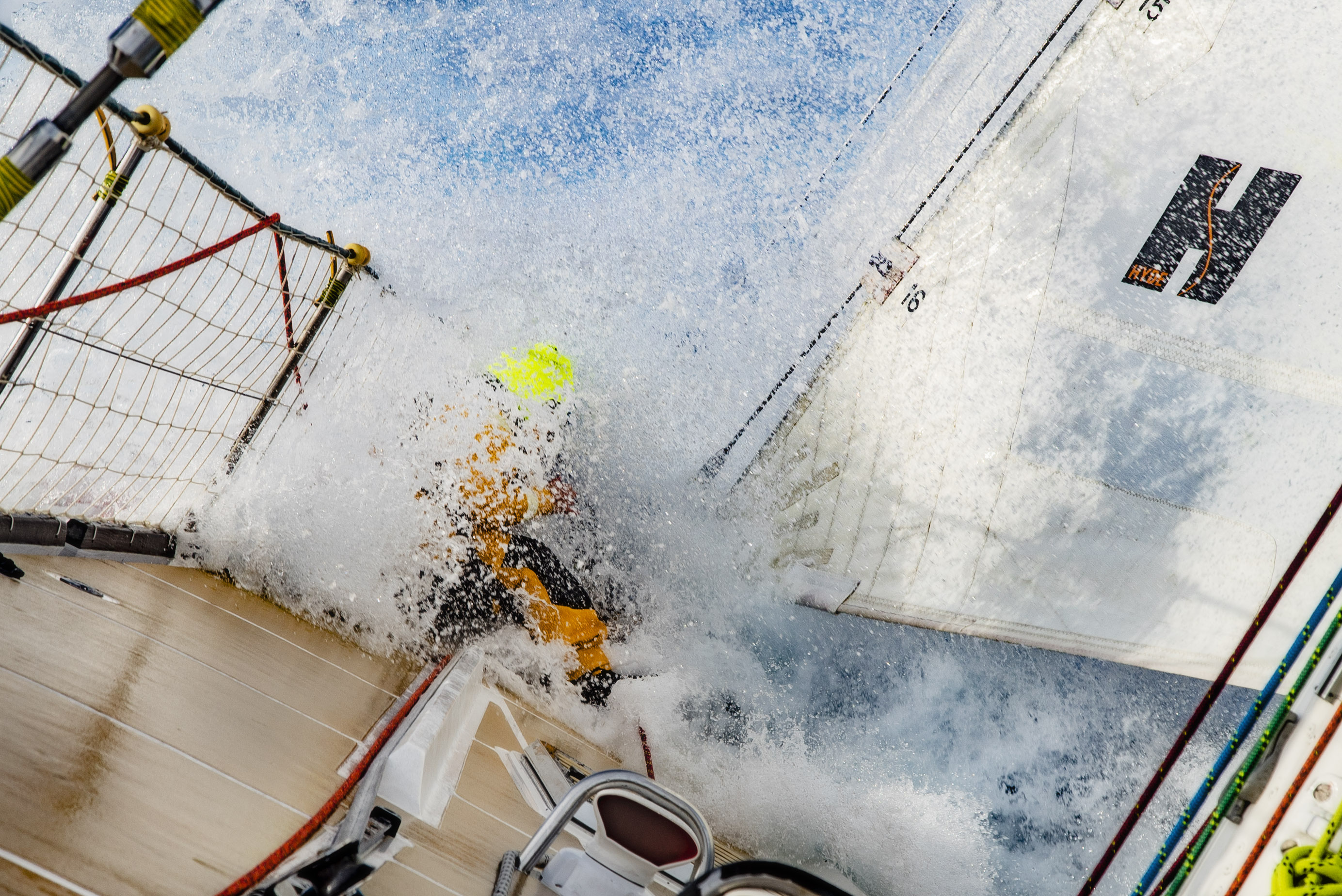 Wave crashing over the bow of a Clipper 70