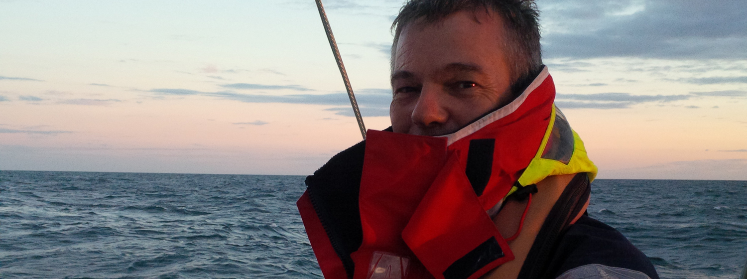 Clipper 2015-16 Race crew member Peter Fitch behind the helm during Clipper Race training