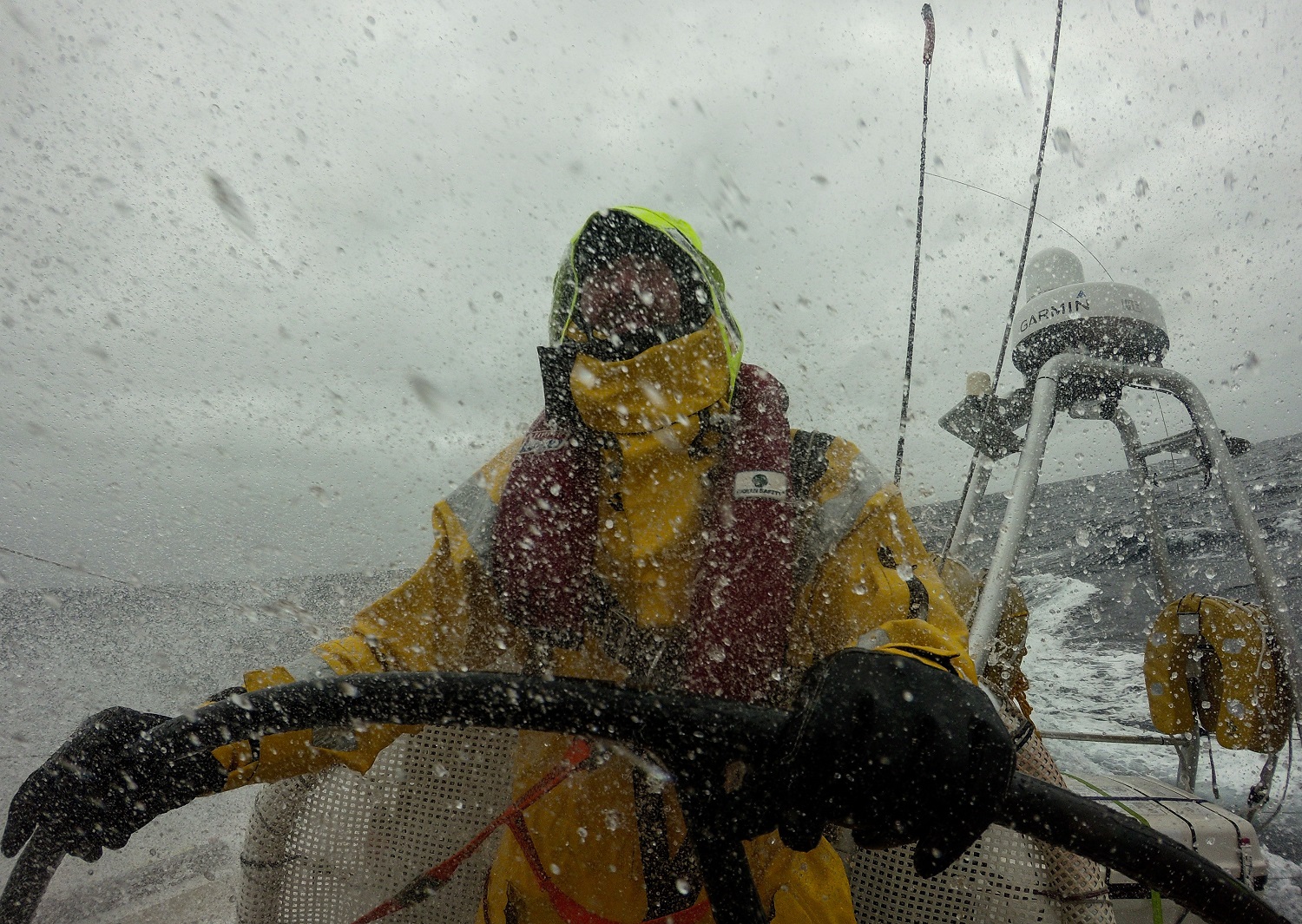 A crew member is pictured in wet conditions whilst helming 