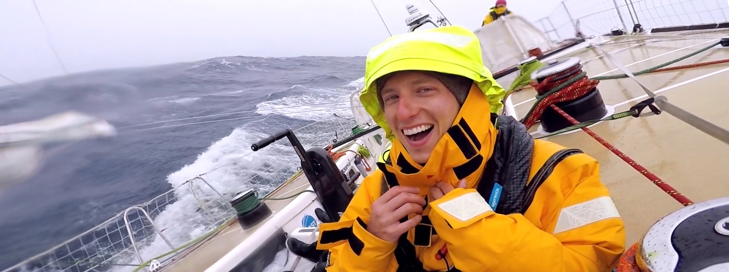 Zhuhai crew member Chris Ball smiling after getting soaked by a wave