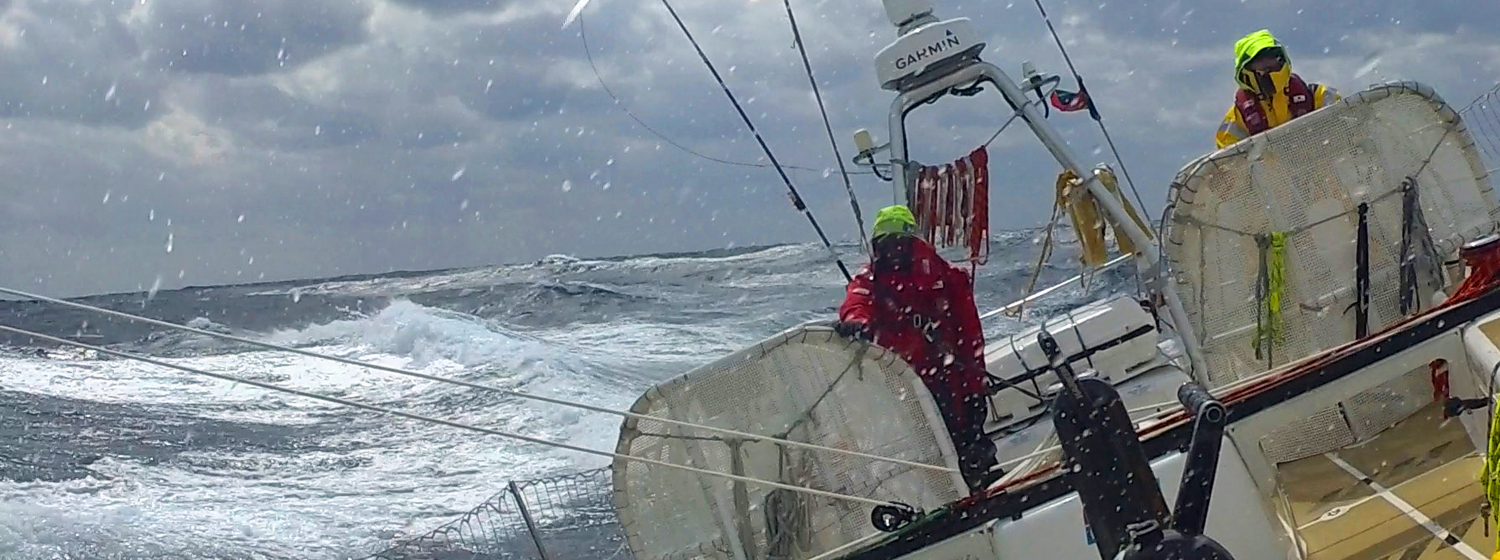 Fernando Arechiga helming on board Dare To Lead in the North Pacific Ocean.