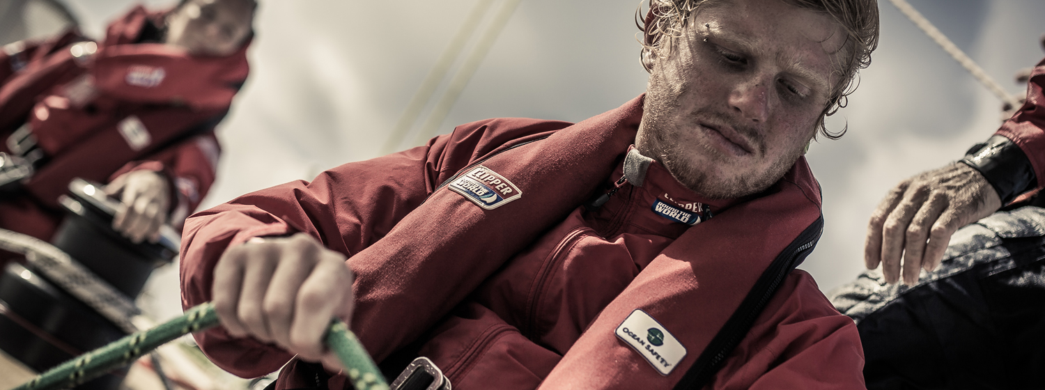 Crew Member working a winch wearing Ocean Safety Lifejacket 