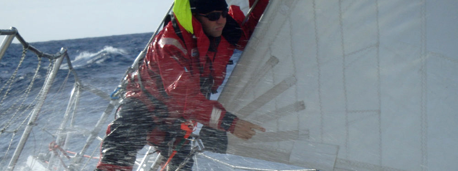 Could this be you? Crew member on bow on Clipper 70-foot ocean racing yacht with spray