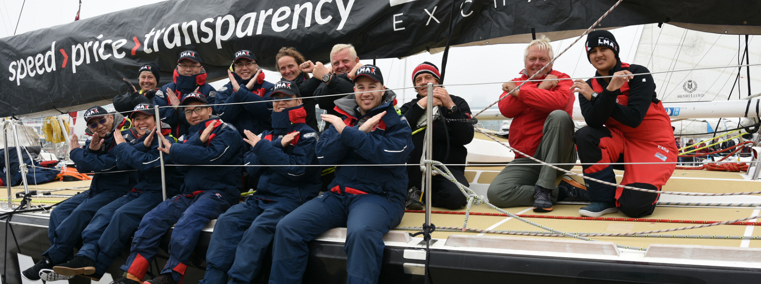 LMAX clients pose on the team boat 