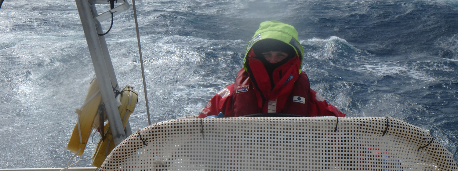 Charlie Stannard behind the helm crossing the Pacific